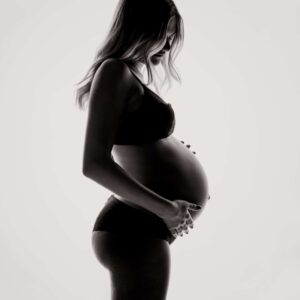 Pregnant woman on a light background