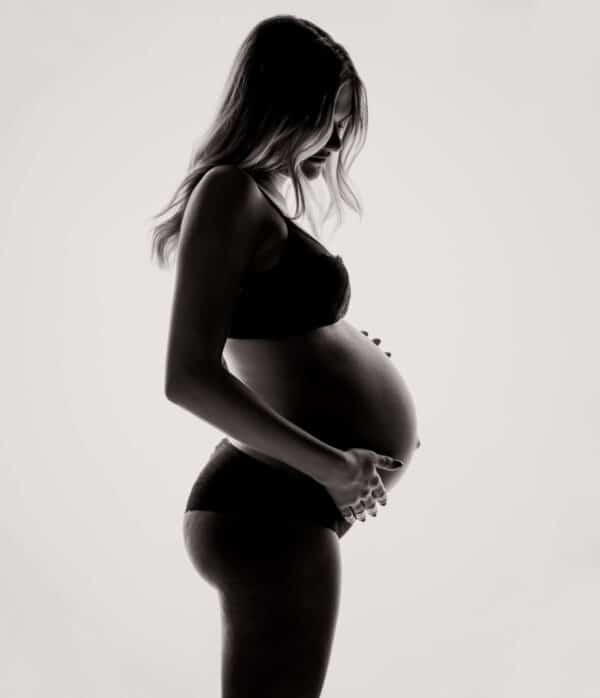 Pregnant woman on a light background